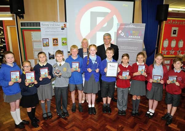 Coun Andrea Kay and Steve Jackson present primary school pupils from Stanah, Northfold, Baines Endowed, Royles Brook, Manor Beach and Thornton Primary with their Community Education Award