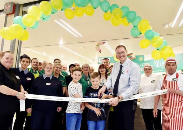 TV advert boys Taylor and Elliot Haydon at the Morrisons ribbon cutting with store manager Greg Matthews and staff