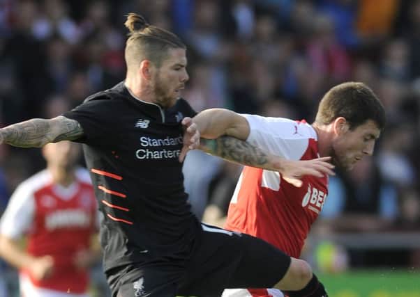 Bobby Grant is challenged by Liverpool's Alberto Moreno