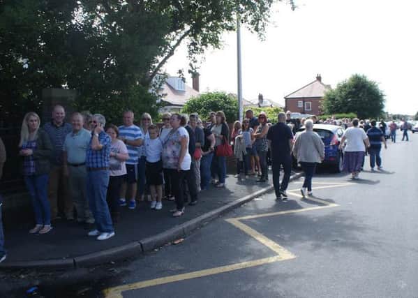 Past pupils of Hawes Side Academy queue down the street waiting to get in to look around the school at a reunion organised before the school is moved to new buildings on the site.