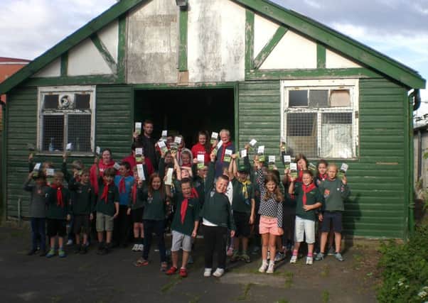 The 8th Lytham St. Annes Cubs holding up the Scout Hut Appeal leaflet which is going to every household in Lytham
