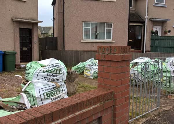 Garden waste piled in the garden of the property in Knowsley Crescent