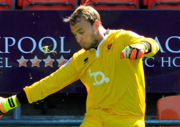 Blackpool keeper Sam Slocombe was called into action at Prenton Park