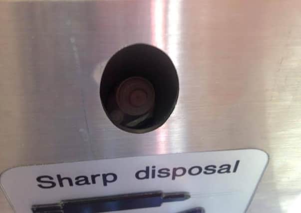 The sharp disposal where Erin Malia pricked her finger on a used syringe. The exposed needle can be seen poking out of the top of the disposal. Picture by Chris Malia