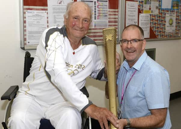 Veteran wheelchair athlete and fundraiser Dave Burns  donates the Olympic Torch he received in 2012 to Blackpool Sports Centre, as a way to help encourage more young people in the town to take up sport.
Dave (left) is pictured presenting the torch to Cllr Graham Cain.