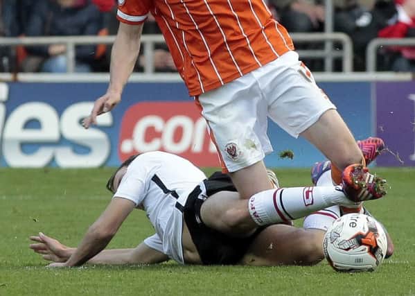 Chris Atkinson (tackling) in action against Blackpool last season; now hes on trial at Bloomfield Road