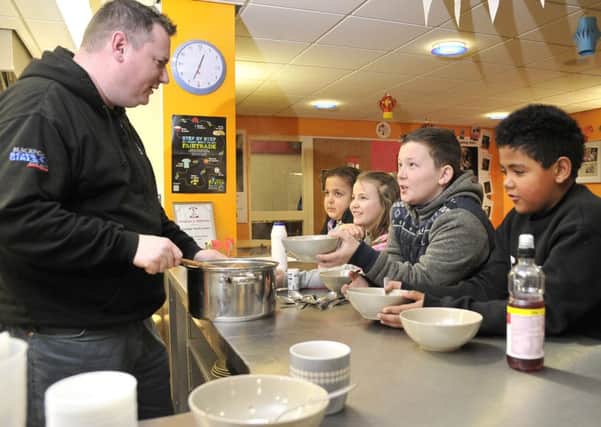 Youth Worker Jed Sullivan serving lunch to, from left, Madison Smith, Emily Appleby, Tyler Masterson and Tyler Shorrocks at Blackpool Boys and Girls Club