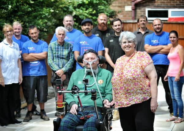 Keith and Kate Smith pictured at their Blackpool home with some of the people who have helped them