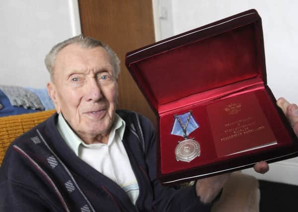 WW2 veteran Peter Kyle is awarded a Ushakov Medal by attachÃ© of the Russian embassy Oleg Shor for his war effort in the Arctic convoys.