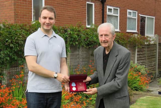 Veteran James Bell receives the Ushakov Medal by attaché of the Russian embassy Oleg Shor for his war effort in the Arctic convoys.