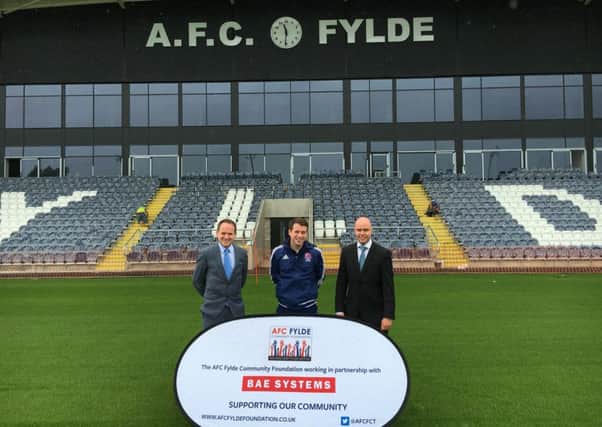 David Coates and Dean Tasker of BAE and (centre) Tom Hutton of the AFC Fylde Community Foundation