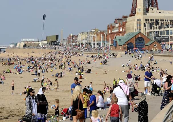 Holidaymakers on 
Blackpool beach 
yesterday