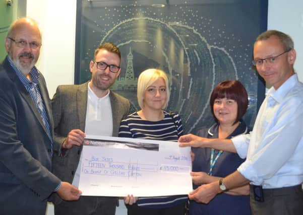 Peter and Simon Cotton and Clare Keane present a cheque for Â£15,000 to Alison Melvin and Pavel Bezecny at the Macmillan Windmill Unit at Blackpool Victoria Hospital