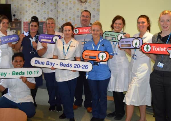 Staff at Blackpool Victoria Hospital with some of the dementia signs which have been bought by Blue Skies Hospitals Fund thanks to Francescas fundraising.