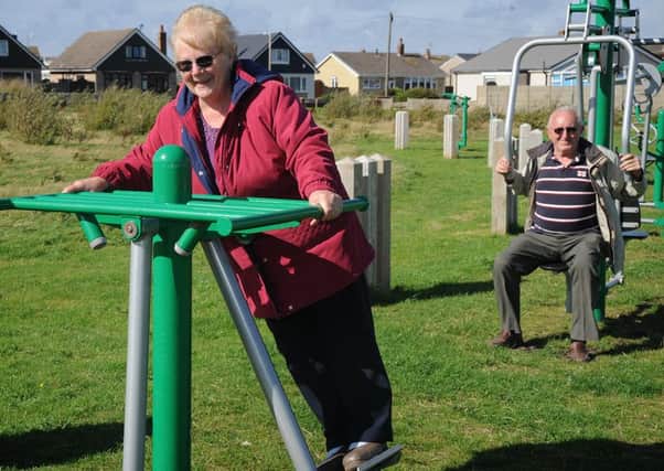 Fleetwood Council are hoping to get permission from Wyre Council to move the exercise machines from Roundway outdoor gym, where they are under-utilised.
Pictured at the gym are Friends of Memorial Park members Ella and Les Fletcher.  PIC BY ROB LOCK
2-9-2016