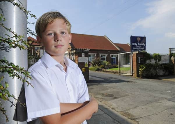 Nine-year-old Oliver McGonigle outside the Holy Family Catholic Primary School