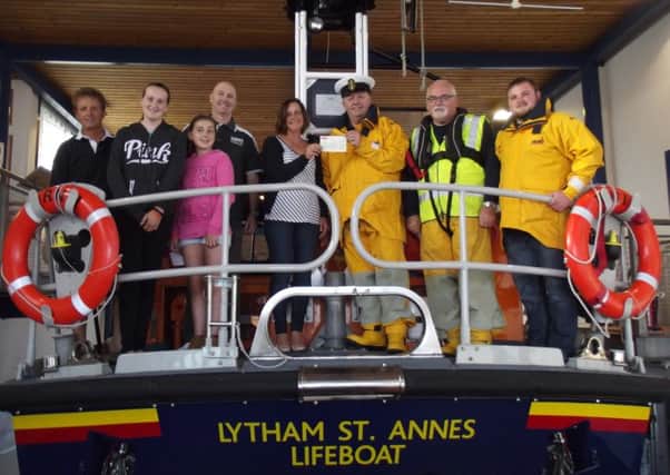The Rowse family of St Annes present a cheque for Â£1,135 to the RNLI