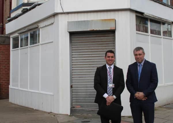 Coun Mark Smith (right) with property services manager Paul Smith outside the refurbished newsagents