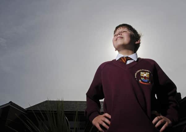 Ten-year-old Charlie Jordan returns to his classmates at St Teresa's Primary School after being away due to illness