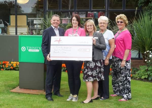 Bob Gallagher of Lytham St George's Festival committee presents a cheque for Â£20,000 to Trinity Hospice representatives (from left)  Linzi Young, head of fundraising; Michelle Lonican, community fundraiser and volunteers Marie Mallinson  and Helen Lomax