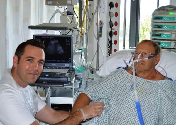 Simon Hayward performs lung ultrasound on heart patient Derek Foulds