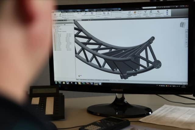 One of the designers looking at a virtual track model