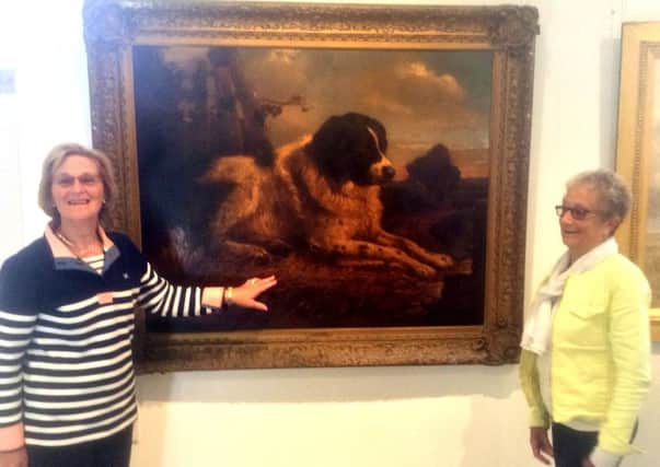 Margaret Race, chairman of the Friends of the Lytham St Annes Art Collection, and friend Wendy Bingham with the painting of a dog in the current Liverpool Infleunces exhibition which it is thought might be by Edwin Henry Landseer