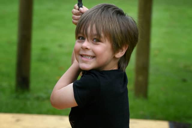 Pictures Martin Bostock. The reopening of Freckleton Memorial Park. 5 year old Marcus Gardner on the rope slide.