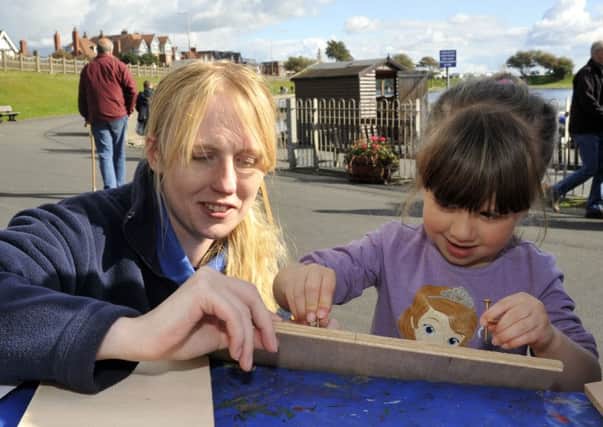 Claire Critchley from Ribble Discovery Centre with Rebecca-Mae Saunders, aged four, building a bird box at the RSPB Fairhaven Lake's Winter Homes Event