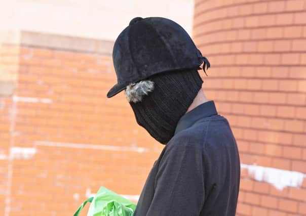 Trussell outside Preston Crown Court this week dressed in the riding helmet and black hat covering his face. Pic by Andy Kelvin
