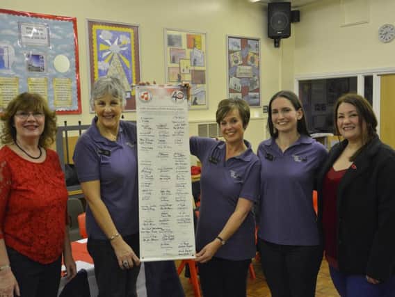 Red Rosettes handing over the beacon to The Cheshire Chord Company. The Mayor of South Ribble Coun Linda Woollard and her consort witnessed the signing of the scroll.