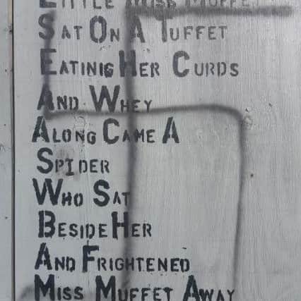 Graffiti on hoardings on the site of the burnt down Grand hotel in Station Road, South Shore