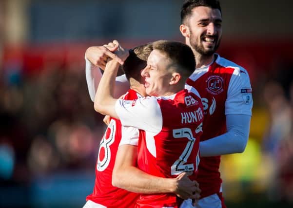 Fleetwood Town's Jack Sowerby celebrates with Conor McLaughlin and Ash Hunter after opening the scoring against Peterborough