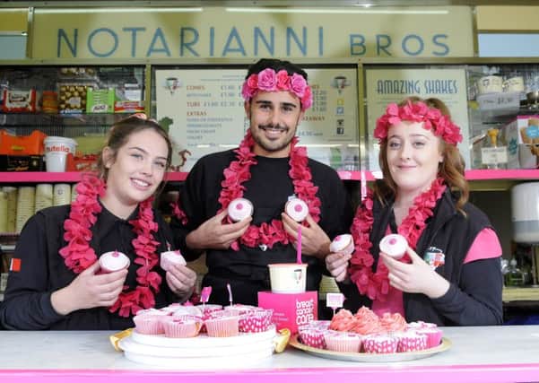 Staff from Notarianni Ice Cream serve pink cupcakes for Breast Cancer Awareness month.  Pictured are Hannah Griffins, Luca Vettese and Katie Fisher.