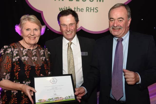 Beryl Smith and Paul Hayhurst of Elswick in Bloom are presented with Elswick's Britain In Bloom gold award by RHS judging panel chairman Roger Burnett
