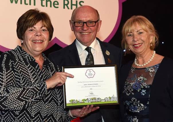 Lytham In Bloom chairman Carol Wildon (left) and vice-chairman Susan Evans receive the town's gold medal award from RHS judge and council member Jon Wheatley