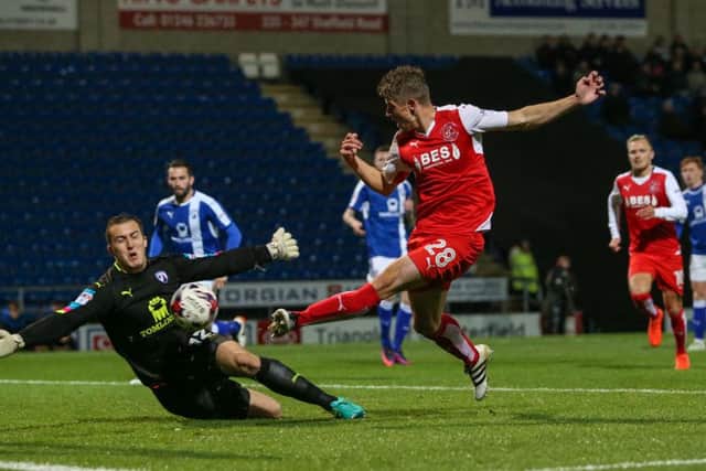 Chesterfield's Ryan Fulton saves at the feet of Fleetwood Town's Jack Sowerby