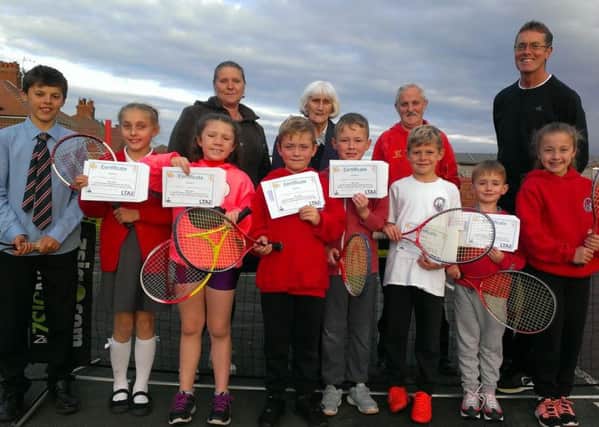 Coun Lily Henderson (back centre) and coach John Cain (back right) with children and parents at the Highfield Park tennis sessions