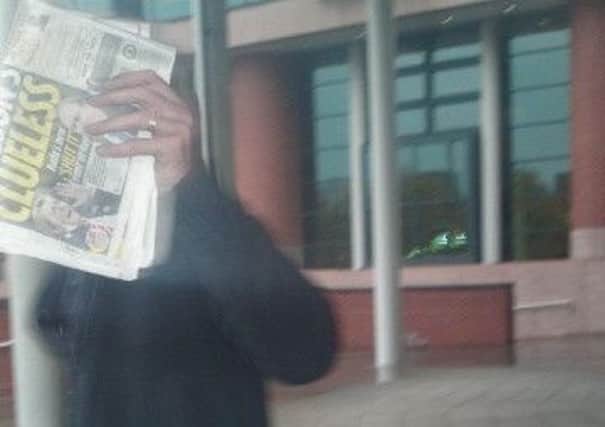 Paul Edensor hides his face outside court after the tram incident verdict
