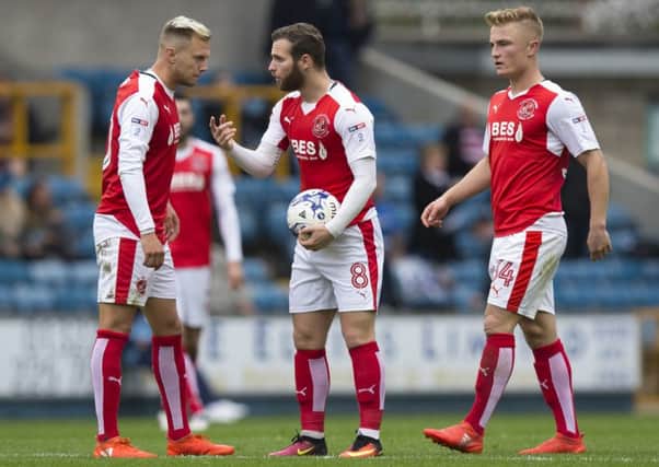 Fleetwood Town's Jimmy Ryan discusses tactics with David Ball and Kyle Dempsey after Fleetwood conceded at Millwall