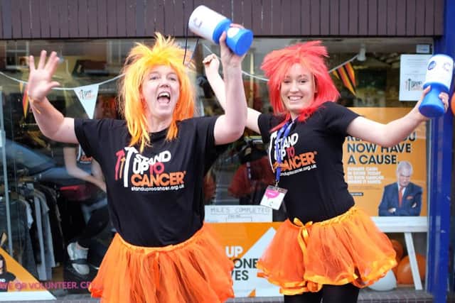 Staff and volunteers from the Cancer Research charity shop take part in a fundraising day for Stand Up To Cancer.  Pictured are Michaela Andrew and Becca Andrew.