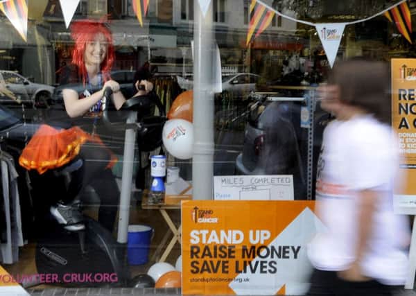 Staff and volunteers from the Cancer Research charity shop take part in a fundraising day for Stand Up To Cancer, including Michaela Andrew and Becca Andrew (above)