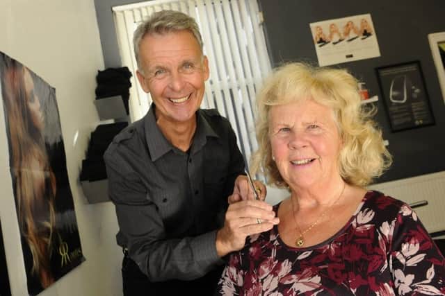 Carl Mills cuts the hair of visually impaired Carole Holmes for the final time at Athena Hair, due to Carl's retirement.