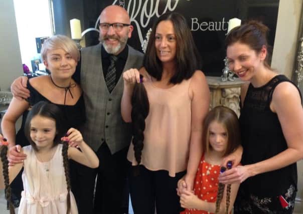 The O'Neill family with staff from Allure Roccoco after having their hair chopped off for the Little Princess Trust