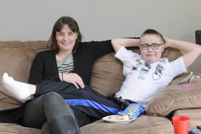 11-year-old Ollie Alderson is back home after spending 10 months in hospital.   He is pictured with mum Anne.