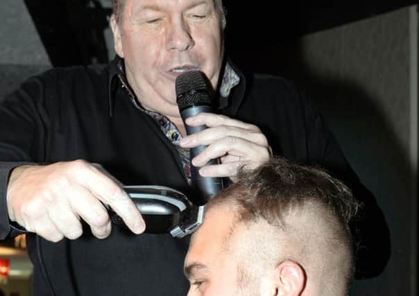 Comedian Joey Blower has raised almost Â£150,000 fopr Cancer Charities by shaving audience members' hair on stage at the Merrie England Bar, North Pier.
 Joey Shaves the head of Chris Rickett.