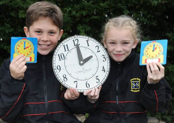 Hawes Side Academy pupils Bradley Baldwin and Kady Jones with a reminder that the clocks go back one hour at 2am on Sunday morning. PIC BY ROB LOCK
27-10-2016