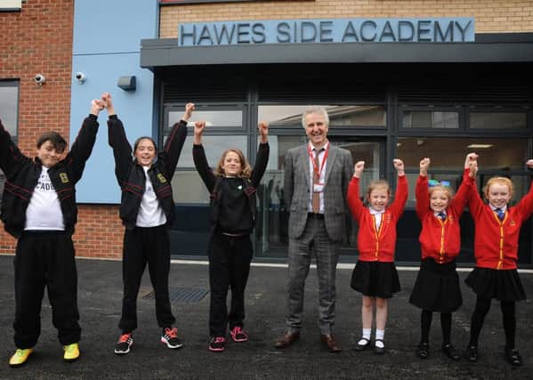 Members of the pupil school council at Hawes Side Aacdemy in Blackpool enjoyed a preview tour of their new school building, which is due to open next month.
Pictured outside the new main entrance are L-R: Taylor, Bethany, Amelia, Head Mike Shepherd, Chloe Gracie and Jasmine.  PIC BY ROB LOCK
27-10-2016
