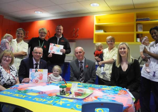 Staff and children at Brian House with visitors from HSBC and Room in the bright new craft area