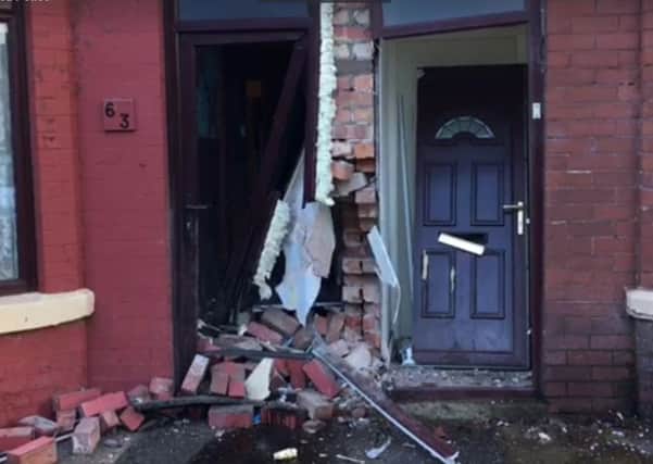 The damaged front doors of two terraced houses in Belmont Avenue